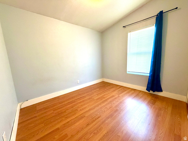 1025 North 300 West, Unit 1 Springville, UT 84663 - Photo 16 of 35 Spare room featuring lofted ceiling and light wood-style floors