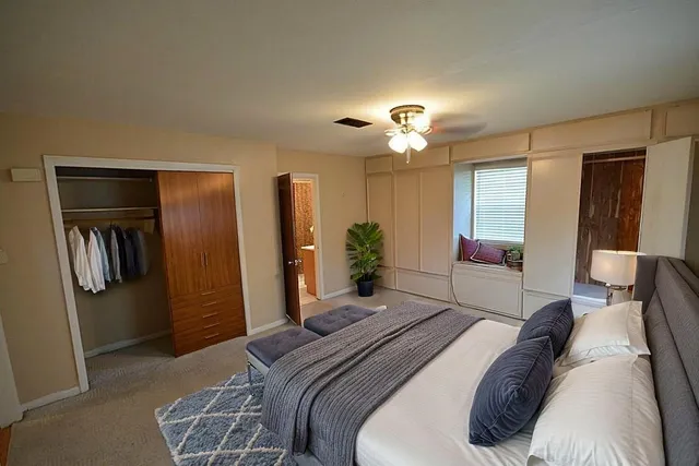 a view of a room with wooden floor and a window