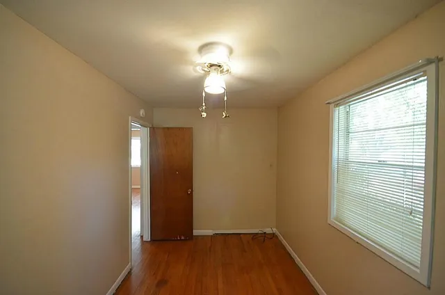 a view of a workspace with furniture and a potted plant