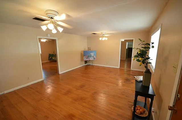 a living room with furniture a chandelier and a flat screen tv