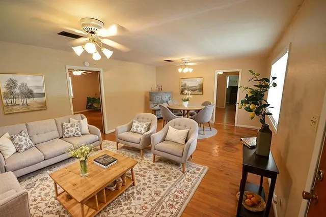 a kitchen with a stove and wooden floor