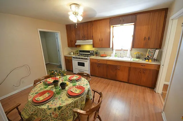 a view of a dining room with furniture and wooden floor