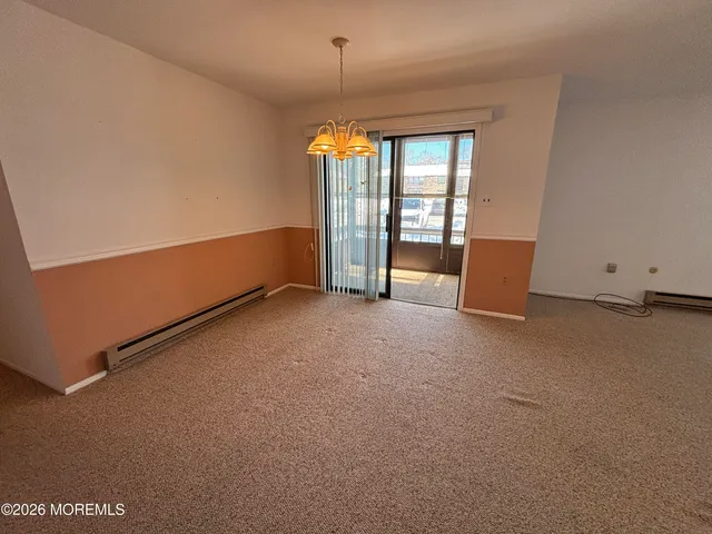 an empty room with wooden floor and a window