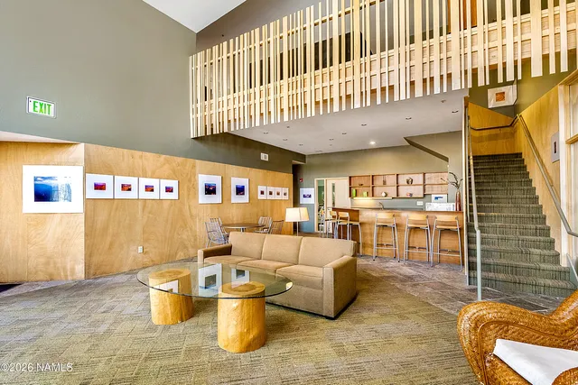 a living room with fireplace furniture and a rug