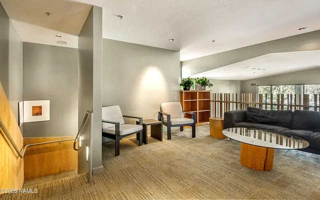a living room with furniture a pool table and a fireplace