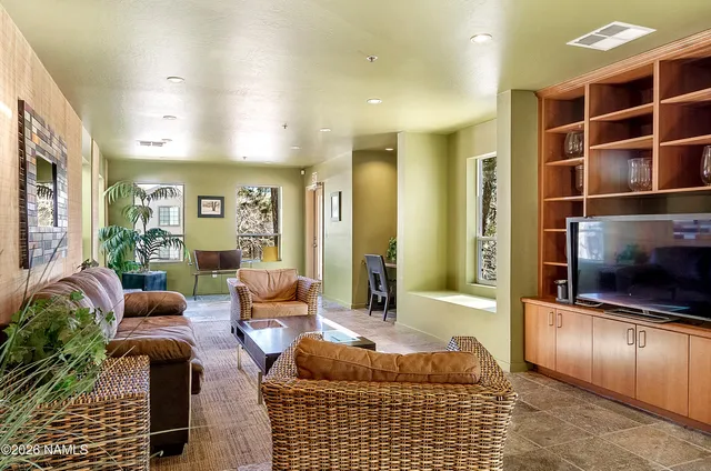 a living room with furniture and a potted plant