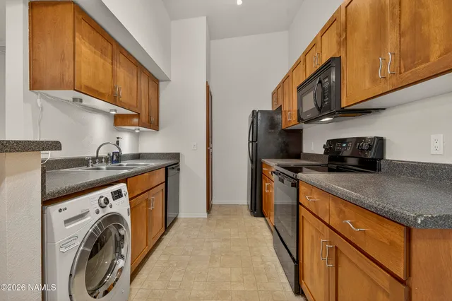 a kitchen with stainless steel appliances granite countertop a sink and cabinets