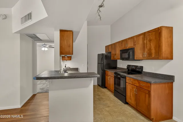 a kitchen with stainless steel appliances a sink stove and refrigerator