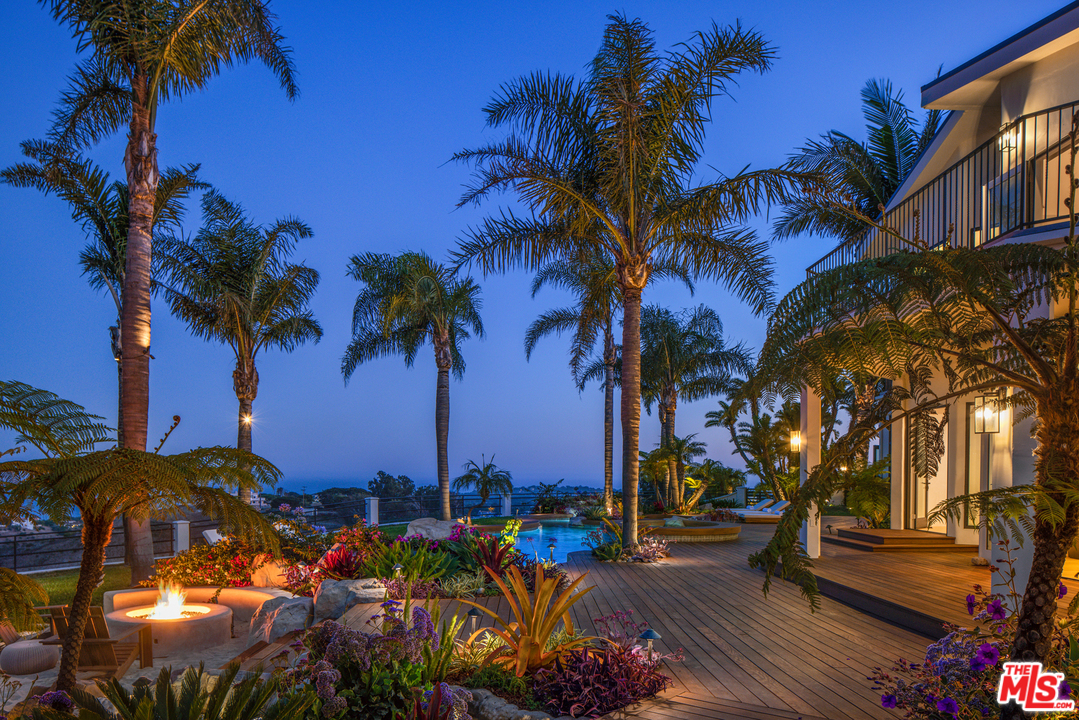 5868 Zumirez Drive Malibu, CA 90265 - Photo 19 of 54 a view of a yard with a palm tree