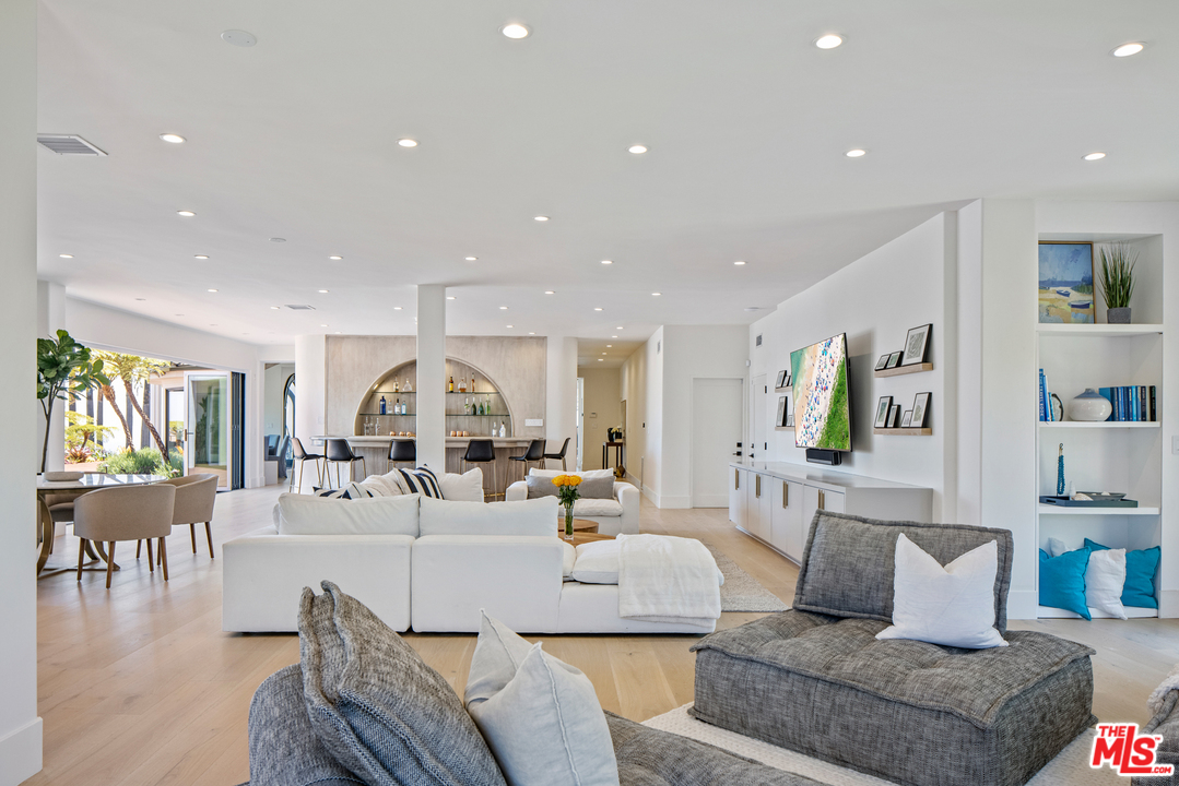 5868 Zumirez Drive Malibu, CA 90265 - Photo 28 of 54 a living room with furniture kitchen view and a large window