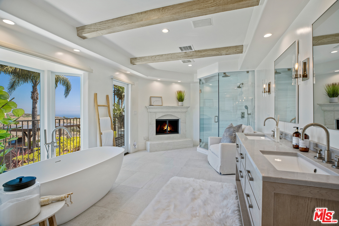 5868 Zumirez Drive Malibu, CA 90265 - Photo 34 of 54 a spacious bathroom with a tub sink and mirror