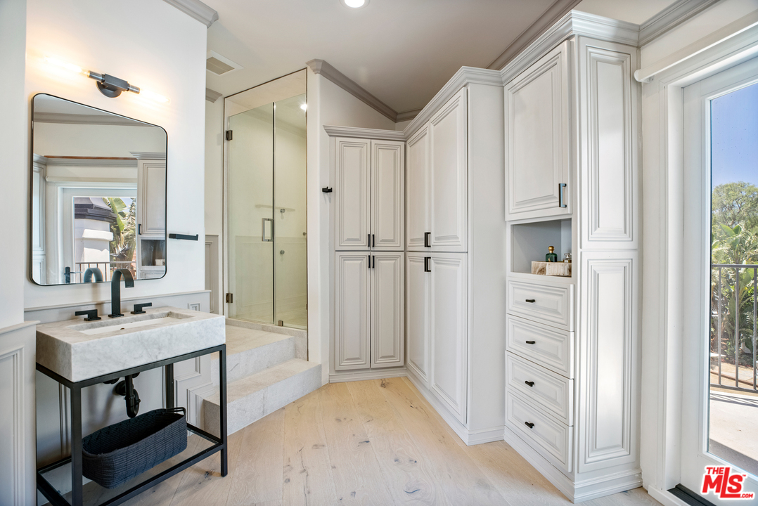 5868 Zumirez Drive Malibu, CA 90265 - Photo 35 of 54 a view of a bathroom with a sink a mirror and a shower