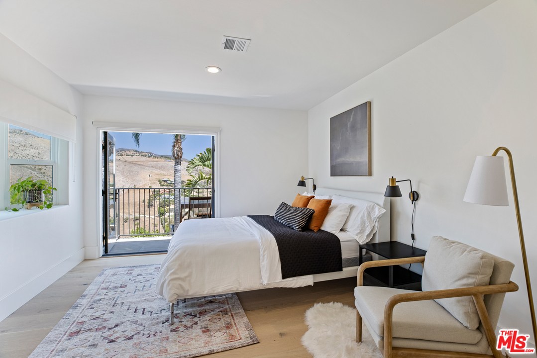 5868 Zumirez Drive Malibu, CA 90265 - Photo 37 of 54 a bedroom with a bed and a window