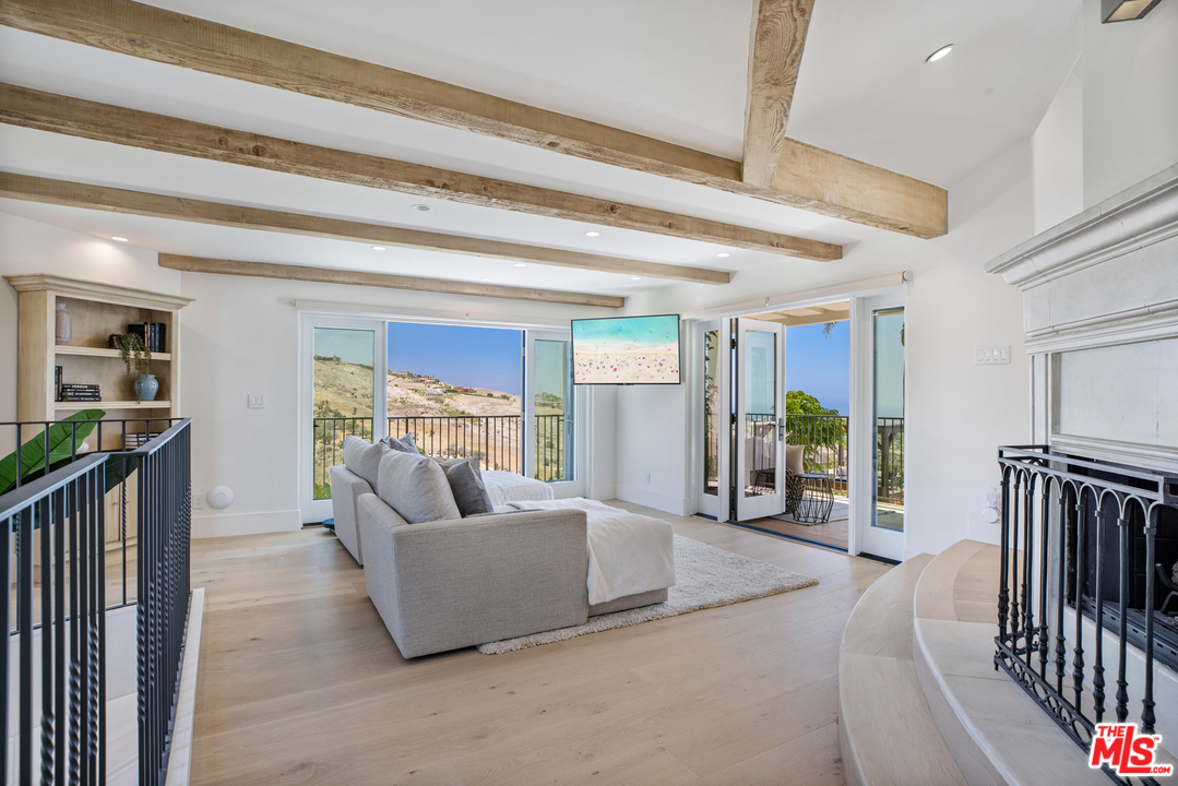 5868 Zumirez Drive Malibu, CA 90265 - Photo 38 of 54 a living room with furniture and a flat screen tv