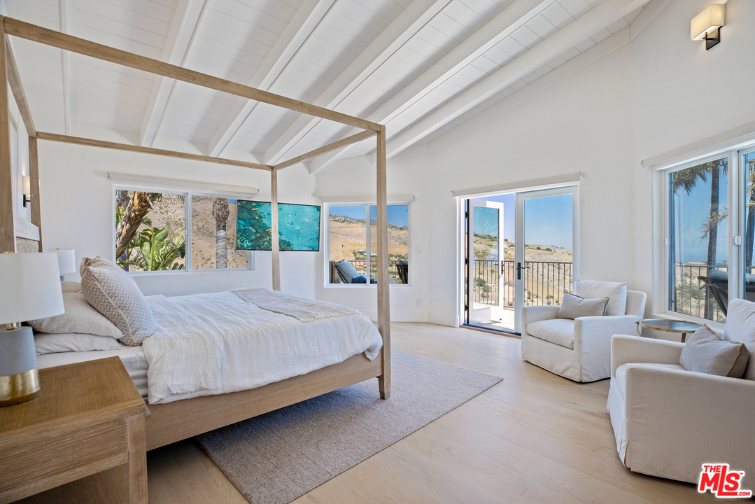 5868 Zumirez Drive Malibu, CA 90265 - Photo 39 of 54 a bedroom with a bed couch and window