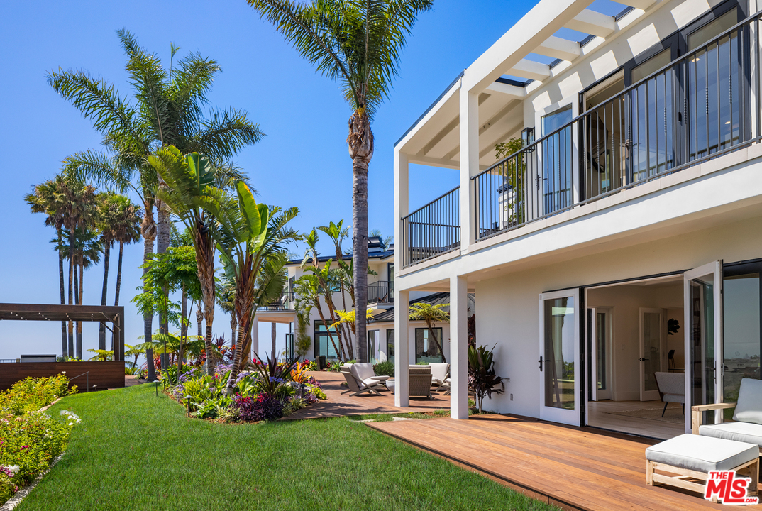 5868 Zumirez Drive Malibu, CA 90265 - Photo 46 of 54 a view of a house with a yard and potted plants