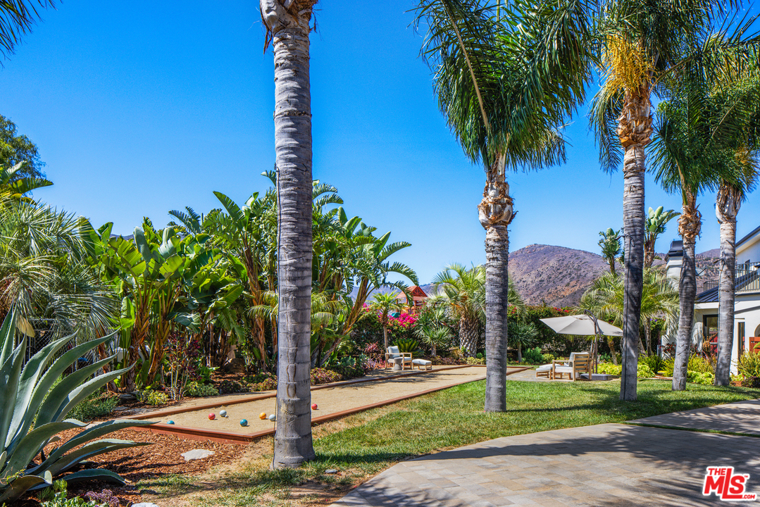 5868 Zumirez Drive Malibu, CA 90265 - Photo 47 of 54 a front view of multi story residential apartment building with yard and sign board