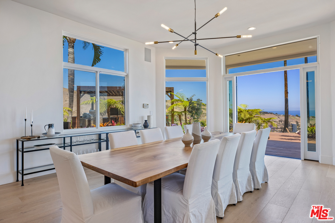 5868 Zumirez Drive Malibu, CA 90265 - Photo 6 of 54 a view of a dining room with furniture window and wooden floor