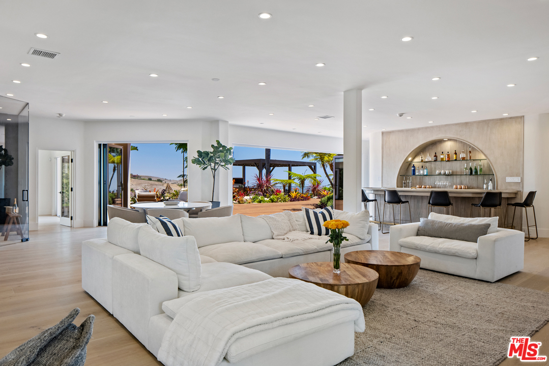 5868 Zumirez Drive Malibu, CA 90265 - Photo 7 of 54 a living room with furniture and a view of kitchen