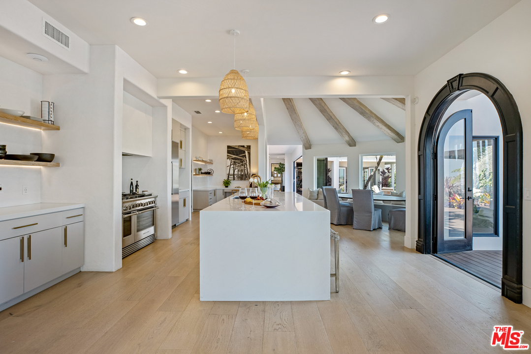 5868 Zumirez Drive Malibu, CA 90265 - Photo 10 of 54 a view of living room kitchen with stainless steel appliances cabinets and a couch