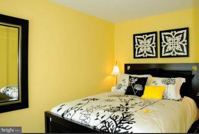 1101 3rd Street Southwest, Unit 210 Washington, DC 20024 - Photo 16 of 28 a bed sitting in a bedroom next to a wall