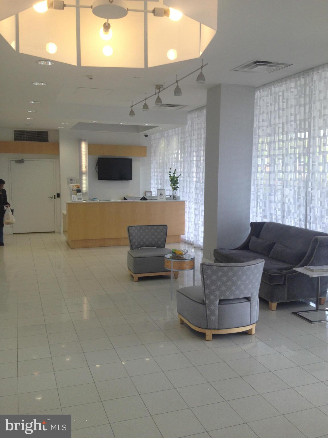 1101 3rd Street Southwest, Unit 210 Washington, DC 20024 - Photo 3 of 28 a living room with furniture and a flat screen tv