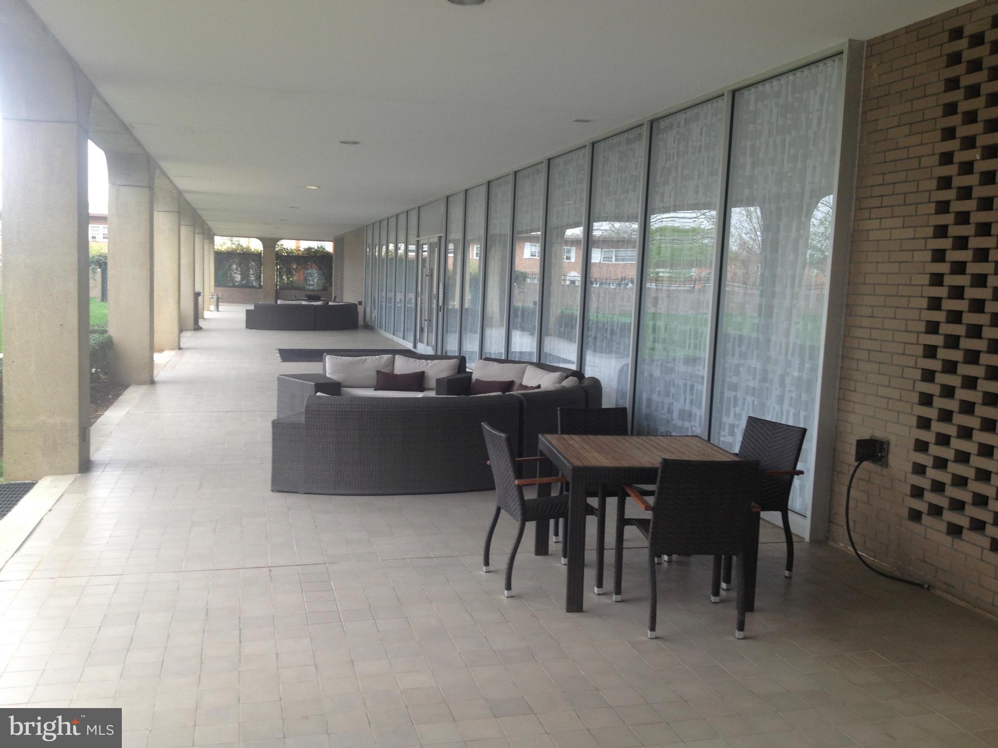 1101 3rd Street Southwest, Unit 210 Washington, DC 20024 - Photo 24 of 28 a living room with furniture a large window and stainless steel appliances