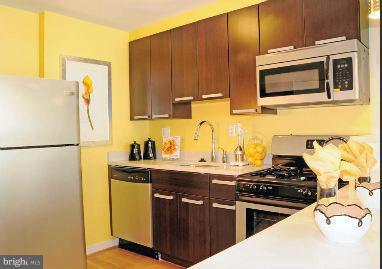 1101 3rd Street Southwest, Unit 210 Washington, DC 20024 - Photo 7 of 28 a kitchen with a sink and a stove