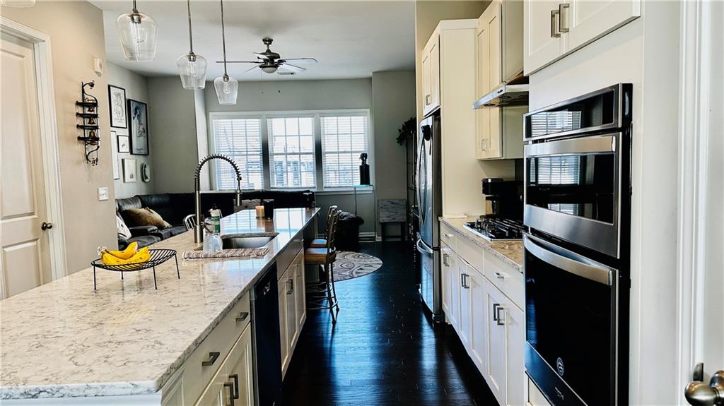 6428 Canopy Drive Sandy Springs, GA 30328 - Photo 12 of 35 a kitchen with stainless steel appliances granite countertop a sink a stove and refrigerator