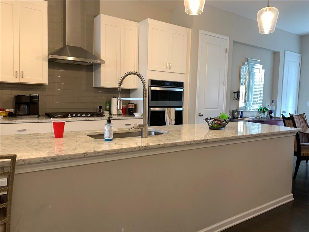 6428 Canopy Drive Sandy Springs, GA 30328 - Photo 15 of 35 a kitchen with stainless steel appliances granite countertop a sink a stove and a refrigerator