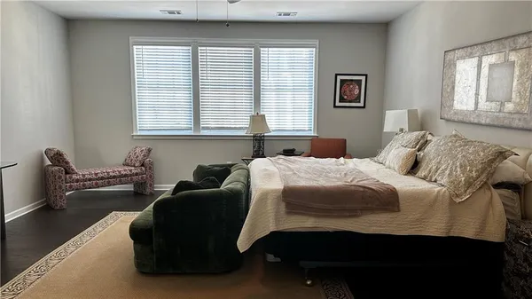 a bedroom with a bed and a couch