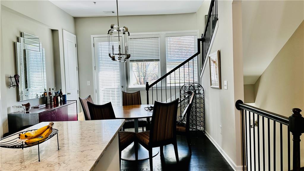 6428 Canopy Drive Sandy Springs, GA 30328 - Photo 10 of 35 a view of a dining room with furniture window and wooden floor