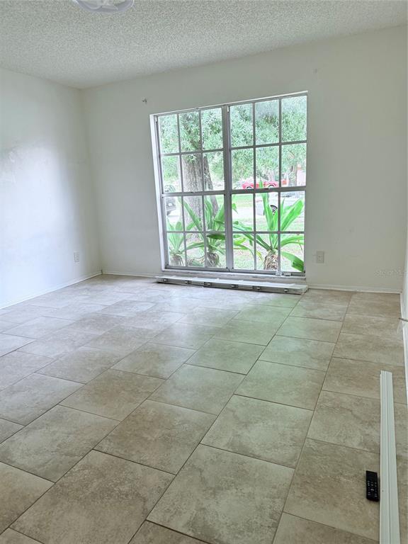 1636 Baker Road Lutz, FL 33559 - Photo 6 of 13 a view of an empty room with a window