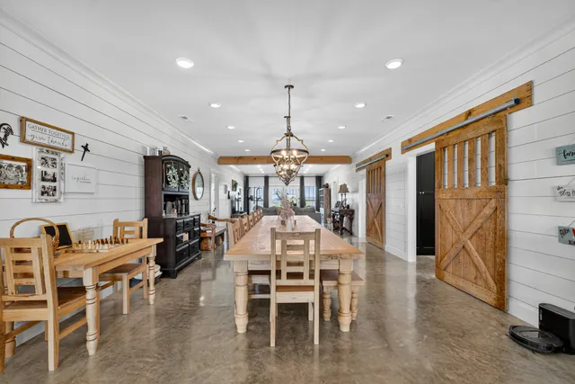 a kitchen with stainless steel appliances kitchen island granite countertop a refrigerator and a sink