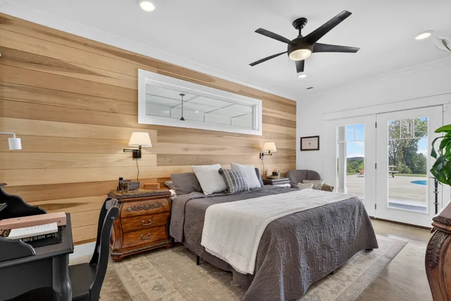 a living room with furniture gym equipment and a large window