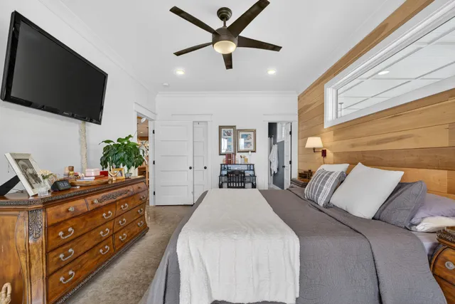 a living room with furniture and paintings on the wall