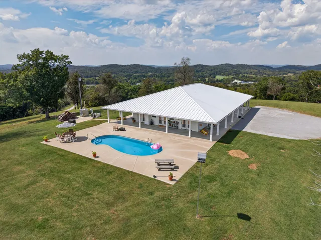 a living room with furniture a flat screen tv and kitchen view