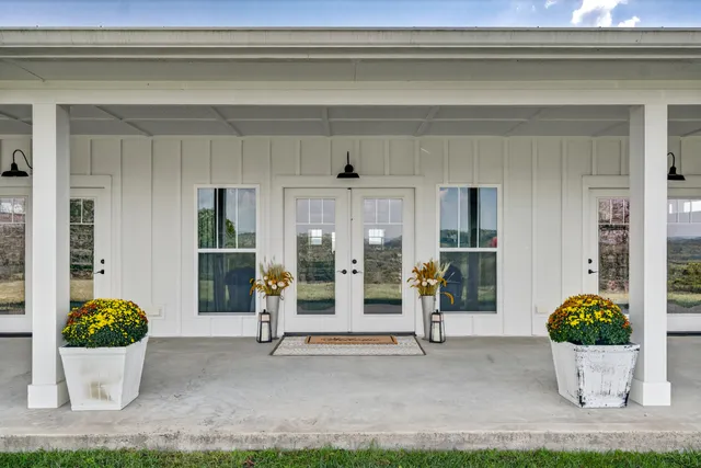 a living room with furniture ceiling fan and a large window