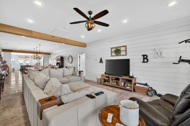 a living room with furniture and a book shelf