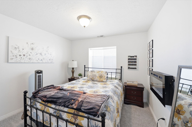 1816 River Bottom Road Springville, UT 84663 - Photo 15 of 37 Carpeted room with a ceiling-mounted light fixture, a window with horizontal blinds, and a wall-mounted electric fireplace