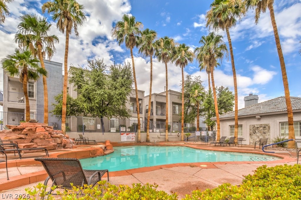 2201 Ramsgate Drive, Unit 1017 Henderson, NV 89074 - Photo 28 of 30 An inviting pool area surrounded by lush palms awaits in this vibrant community setting.