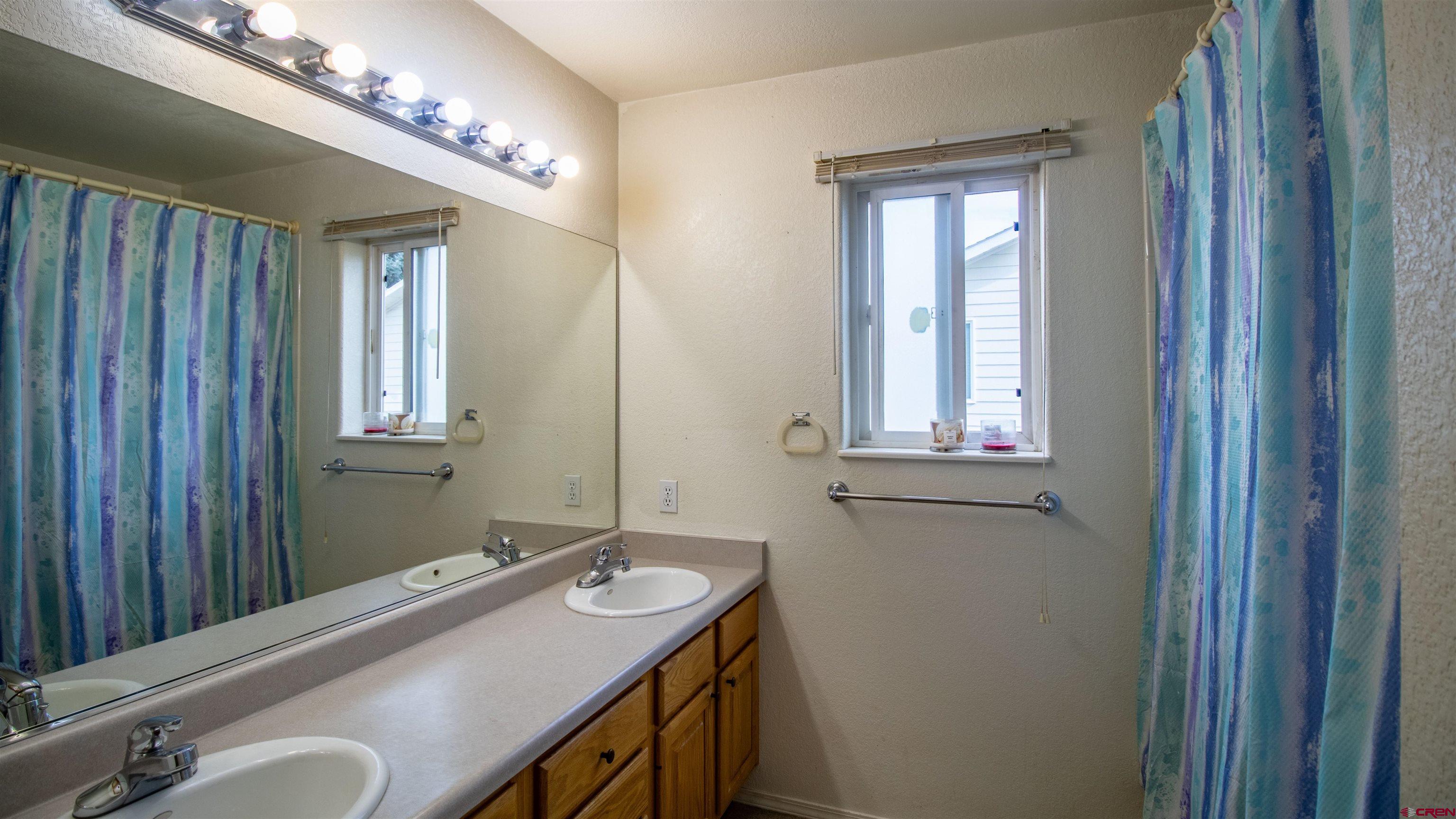 609 Heather Lane Montrose, CO 81401 - Photo 12 of 34 a bathroom with a sink and a mirror