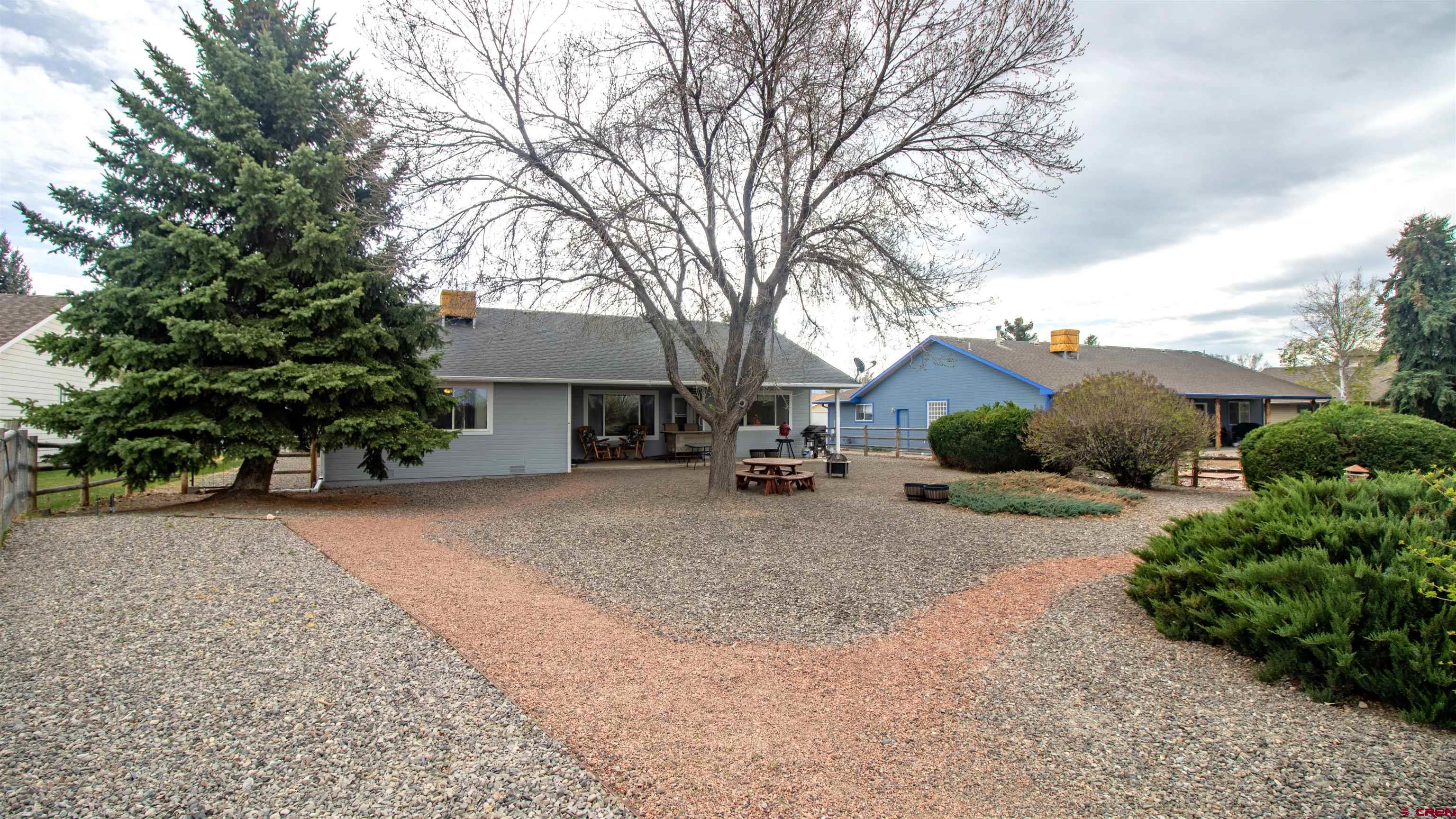 609 Heather Lane Montrose, CO 81401 - Photo 32 of 34 a front view of a house with a yard and garage