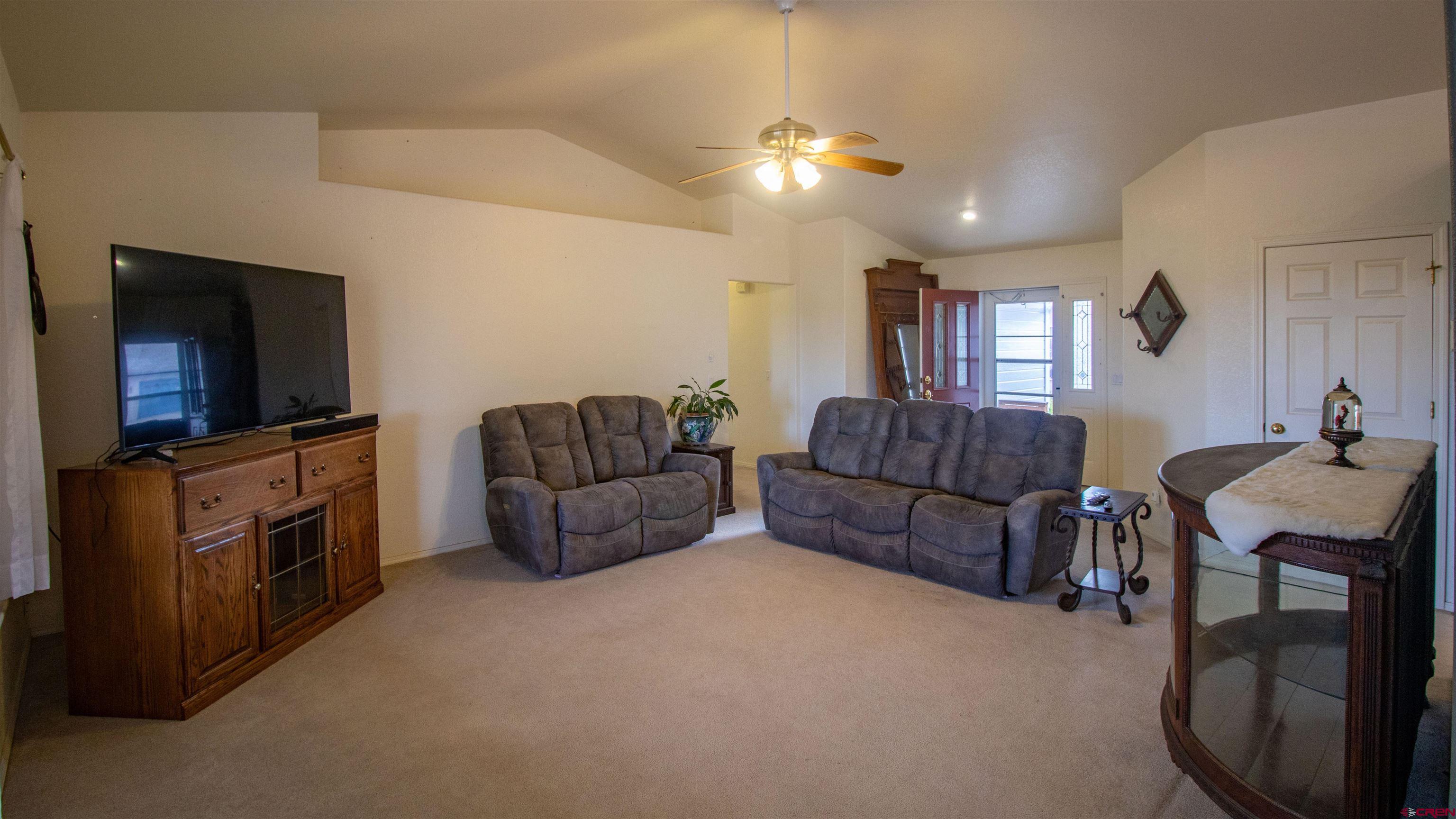 609 Heather Lane Montrose, CO 81401 - Photo 7 of 34 a living room with furniture and a flat screen tv