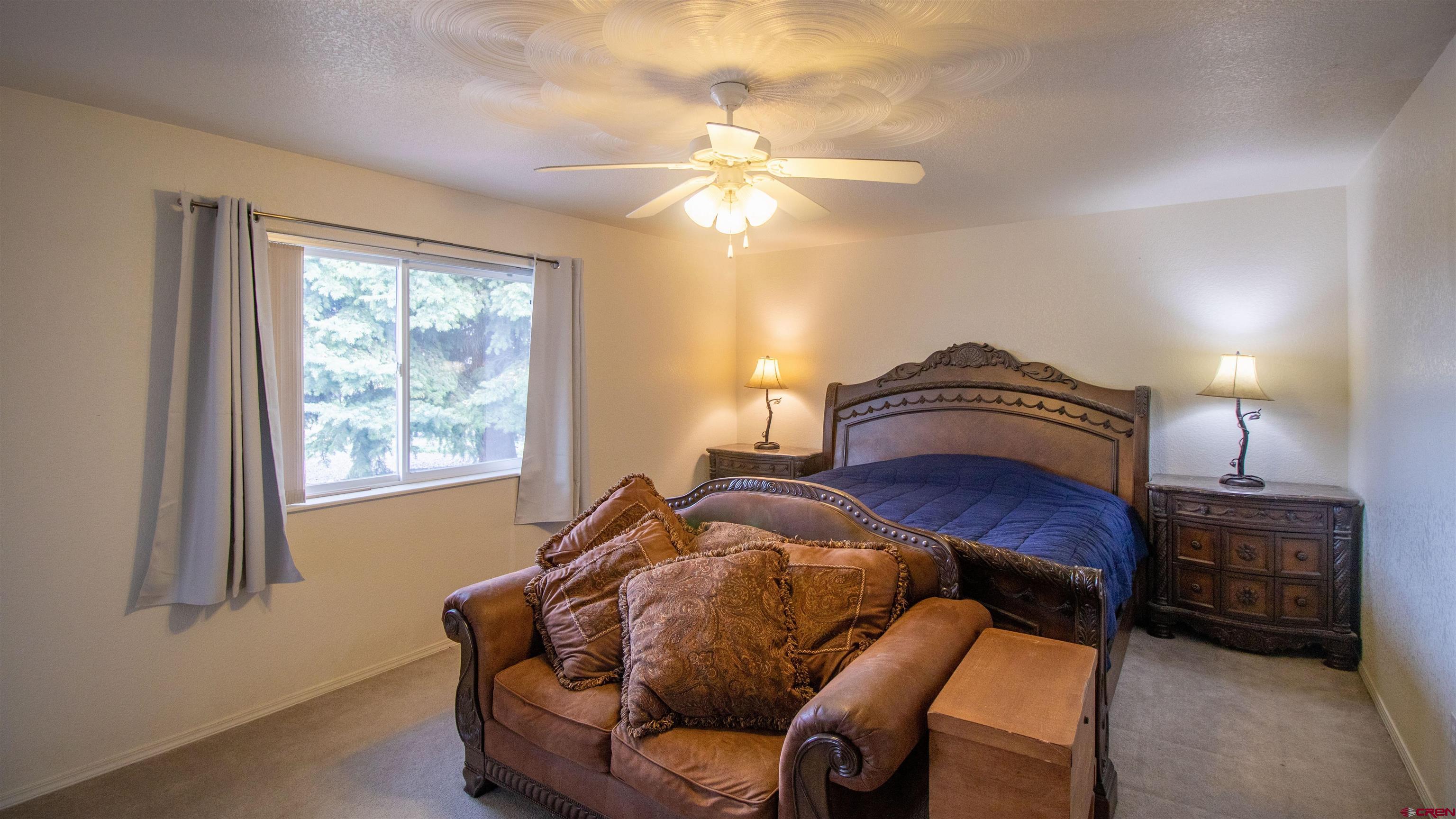 609 Heather Lane Montrose, CO 81401 - Photo 10 of 34 a living room with furniture a window and a chandelier
