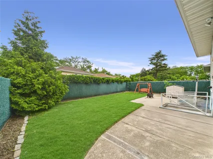 a view of a house with backyard sitting area and garden