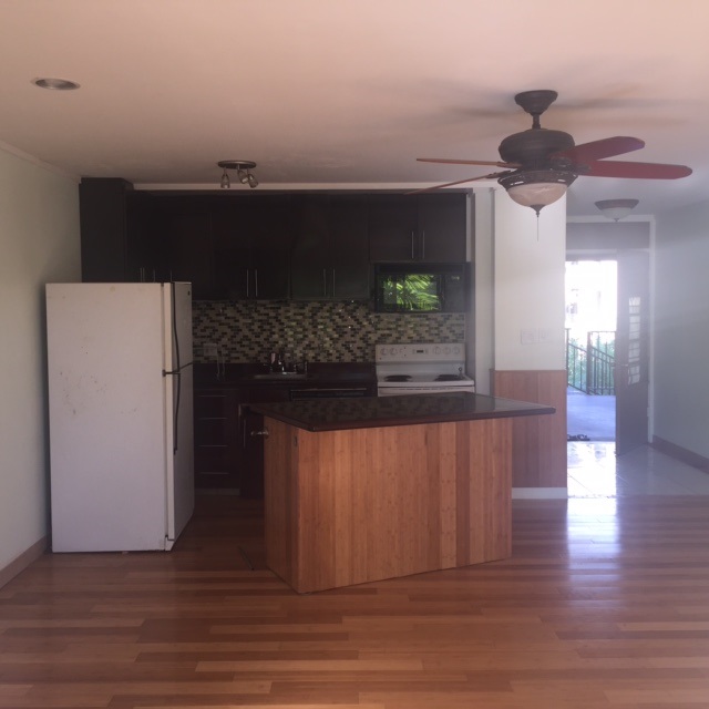 3559 Lower Honoapiilani Road, Unit 718 Lahaina, HI 96761 - Photo 12 of 23 a living room with furniture and a wooden floor