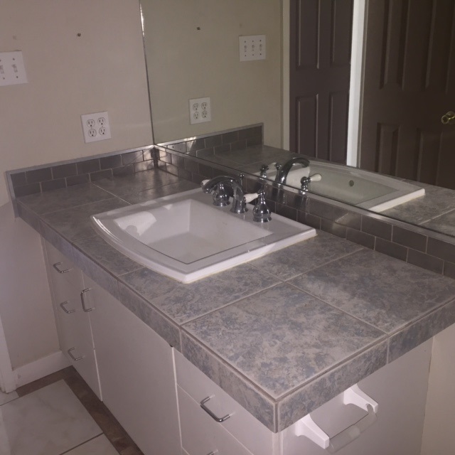 3559 Lower Honoapiilani Road, Unit 718 Lahaina, HI 96761 - Photo 17 of 23 a bathroom with a sink and a mirror