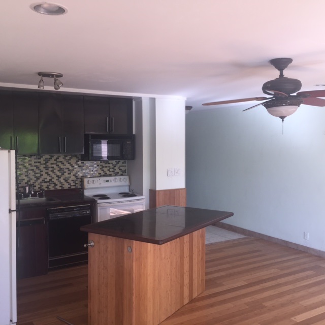 3559 Lower Honoapiilani Road, Unit 718 Lahaina, HI 96761 - Photo 7 of 23 a kitchen with kitchen island stainless steel appliances a sink and cabinets
