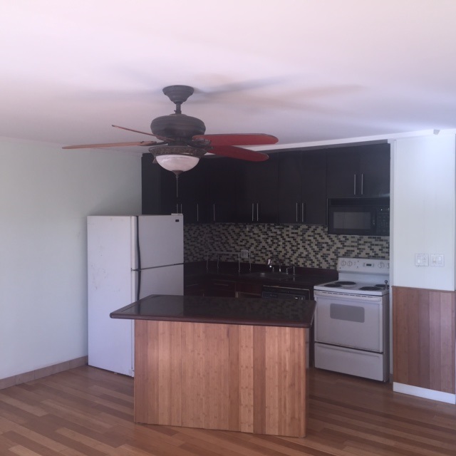 3559 Lower Honoapiilani Road, Unit 718 Lahaina, HI 96761 - Photo 8 of 23 a kitchen with a stove and a refrigerator